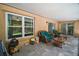 Spacious covered patio with tile flooring, comfortable seating, and an outdoor ceiling fan at 612 Heron Bay Dr, Orlando, FL 32825
