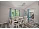 Inviting dining room with a large table, stylish chairs, and serene views from the windows at 612 Heron Bay Dr, Orlando, FL 32825
