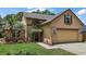 Charming two-story home with a well-manicured lawn, lush landscaping, and a welcoming entrance at 612 Heron Bay Dr, Orlando, FL 32825