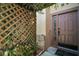 Charming front entrance with a brown door, textured wall, and decorative lattice for added curb appeal at 612 Heron Bay Dr, Orlando, FL 32825