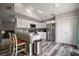 Bright kitchen with white cabinets, a breakfast bar, stainless steel appliances, and modern lighting at 612 Heron Bay Dr, Orlando, FL 32825