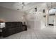 Open-concept living room featuring tile floors, neutral walls, and a modern staircase at 612 Heron Bay Dr, Orlando, FL 32825