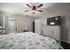 Comfortable main bedroom with ensuite bathroom access, featuring a large bed and a ceiling fan at 612 Heron Bay Dr, Orlando, FL 32825