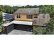 Rear exterior of home with screened in lanai, mature trees, and solar panels at 612 Heron Bay Dr, Orlando, FL 32825