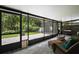 Relaxing screened patio with comfortable wicker furniture and a view of the green backyard at 612 Heron Bay Dr, Orlando, FL 32825