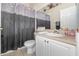 Cozy bathroom with gray shower curtain, single sink vanity, and neutral colored walls and flooring at 637 Blenheim Loop, Winter Springs, FL 32708