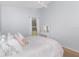 Bright bedroom with natural light, decorated with a white bed and pink accents at 637 Blenheim Loop, Winter Springs, FL 32708