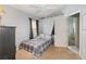 Bedroom boasts a large window, ceiling fan, and an open doorway to adjacent rooms at 637 Blenheim Loop, Winter Springs, FL 32708