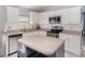 A bright kitchen with white cabinets, stainless steel appliances, and tile backsplash at 637 Blenheim Loop, Winter Springs, FL 32708