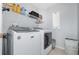 Convenient laundry room with modern washer and dryer, storage shelves and tile floors at 637 Blenheim Loop, Winter Springs, FL 32708