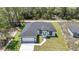 An aerial shot showcasing the home, its driveway, surrounding yard, and nearby trees at 6691 Sw 151Sr Loop, Ocala, FL 34473