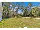 Backyard featuring a lush green lawn with mature trees creating a private serene setting at 6691 Sw 151Sr Loop, Ocala, FL 34473