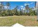 Backyard featuring a lush green lawn with mature trees creating a private serene setting at 6691 Sw 151Sr Loop, Ocala, FL 34473