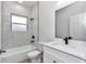 This bathroom features a soaking tub, a window, and modern black fixtures at 6691 Sw 151Sr Loop, Ocala, FL 34473