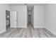 This bedroom has light hardwood floors and a view into the kitchen at 6691 Sw 151Sr Loop, Ocala, FL 34473