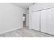 This bedroom has light hardwood floors and a closet with double doors at 6691 Sw 151Sr Loop, Ocala, FL 34473