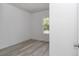 Bedroom with light gray wood flooring and a window at 6691 Sw 151Sr Loop, Ocala, FL 34473