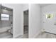 Bright entryway with a view to a bathroom and light gray wood floors throughout at 6691 Sw 151Sr Loop, Ocala, FL 34473