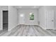 Well-lit entryway with light gray wood flooring and white walls at 6691 Sw 151Sr Loop, Ocala, FL 34473