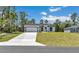 A charming single-story home boasting a well-manicured lawn and a modern white exterior with black trim at 6691 Sw 151Sr Loop, Ocala, FL 34473