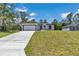 A charming single-story home boasting a well-manicured lawn and a modern white exterior with black trim at 6691 Sw 151Sr Loop, Ocala, FL 34473