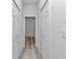 Hallway with wood floors and doors to various rooms at 6691 Sw 151Sr Loop, Ocala, FL 34473