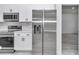Close up view of stainless steel appliances, quartz countertops, and white cabinets in the kitchen at 6691 Sw 151Sr Loop, Ocala, FL 34473