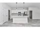 Modern kitchen featuring white cabinets, quartz countertops, stainless steel appliances, and an island with pendant lighting at 6691 Sw 151Sr Loop, Ocala, FL 34473