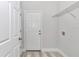 This laundry room features a utility sink and built-in storage shelves at 6691 Sw 151Sr Loop, Ocala, FL 34473