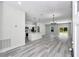 Spacious, open-concept floor plan with kitchen, hardwood floors, natural light, and modern fixtures at 6691 Sw 151Sr Loop, Ocala, FL 34473