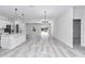 Open concept living area with kitchen, hardwood floors, and bright modern lighting at 6691 Sw 151Sr Loop, Ocala, FL 34473