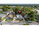 Aerial view of a home, showing its location, roof, and surrounding neighborhood with mature trees at 674 Douglas Ave, Winter Park, FL 32789