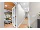 Bright hallway leads to living area with comfortable gray sofa and views of the outdoors at 674 Douglas Ave, Winter Park, FL 32789