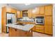 Kitchen with granite countertops, stainless appliances, island cooktop and terracotta tile flooring at 674 Douglas Ave, Winter Park, FL 32789