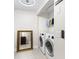Bright laundry room with modern washer and dryer, ample storage, and tile flooring at 674 Douglas Ave, Winter Park, FL 32789