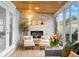 Cozy sunroom featuring a stone fireplace, French doors, and large glass windows at 674 Douglas Ave, Winter Park, FL 32789