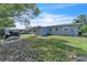 Back of house with windows, yard, ladder, and shed at 7033 Budapest Way, Orlando, FL 32822
