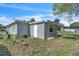 Shows back of house with side door and small window at 7033 Budapest Way, Orlando, FL 32822