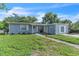 Charming single-story home with light blue siding, green lawn, and welcoming front entrance at 7033 Budapest Way, Orlando, FL 32822
