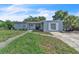 Charming single-story home with light blue siding, green lawn, and spacious driveway at 7033 Budapest Way, Orlando, FL 32822