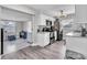 Bright kitchen features white cabinets, gray countertops and stainless steel appliances at 7033 Budapest Way, Orlando, FL 32822