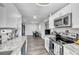 Bright kitchen area with sleek appliances, white cabinets, and modern lighting at 7033 Budapest Way, Orlando, FL 32822