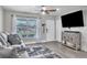 Inviting living room with wood-look floors, TV, and large window at 7033 Budapest Way, Orlando, FL 32822