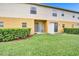 A cozy backyard featuring a well-maintained lawn, small patio, and tidy hedges for outdoor relaxation at 707 N Marotta Loop, Ocoee, FL 34761