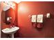 Cozy half bath with a stylish oval mirror, vessel sink, and decorative towels at 707 N Marotta Loop, Ocoee, FL 34761