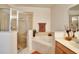 Well-lit bathroom displays a glass-enclosed shower, separate tub, and a tiled accent wall at 707 N Marotta Loop, Ocoee, FL 34761