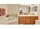 Bright bathroom showcases a double sink vanity, soaking tub, and neutral tile work at 707 N Marotta Loop, Ocoee, FL 34761