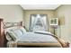 Bedroom with comfy bed, window with curtains, wooden furniture, and a TV at 707 N Marotta Loop, Ocoee, FL 34761