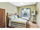 Bedroom with comfy bed, window with curtains, wooden furniture, and a TV at 707 N Marotta Loop, Ocoee, FL 34761