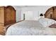 Cozy bedroom featuring elegant bedding, wooden furniture set, and a calm, neutral color palette at 707 N Marotta Loop, Ocoee, FL 34761